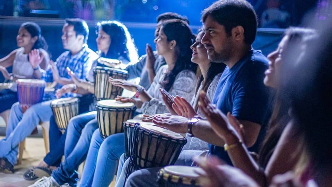 Corporate drum circle activity that builds teamwork, communication, and employee engagement through rhythm