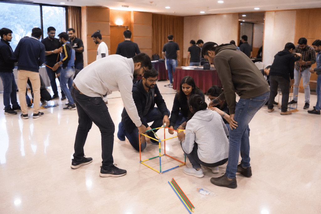Indoor team building activities in Mahabaleshwar — corporate group participating in team challenge at resort