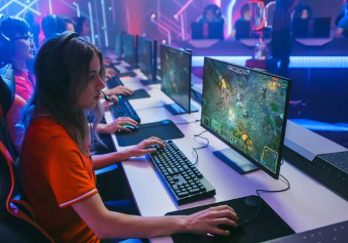 Pro Girl Plays Computer Game Plays RPG Strategy on a Championship. Diverse Esport Team of Pro Gamers Play in Mock-up Video Game. Stylish Neon Cyber Games Arena. Side View Shot